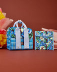 Colorful floral-patterned bag and pouch on a brown background