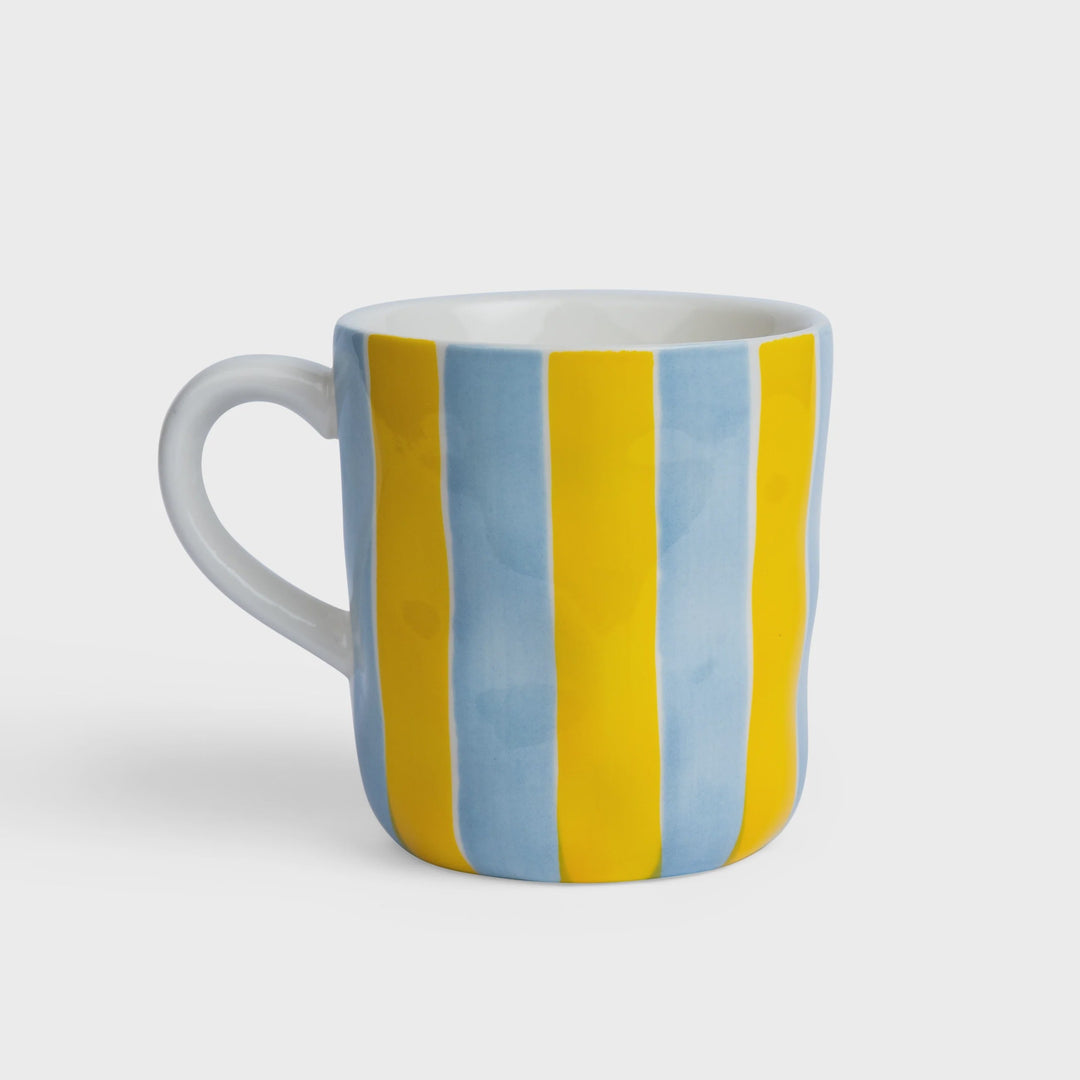 Mug with blue and yellow striped design on a white background