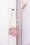 A fashionable cross body mini case in a sweet little floral print. The cutest size and adjustable strap. A cute perfect first bag for your little ones accessories collection. Available from www.thecollectivenz.com