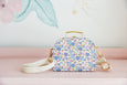 A fashionable cross body mini case in a sweet little floral print. The cutest size and adjustable strap. A cute perfect first bag for your little ones accessories collection. Available from www.thecollectivenz.com