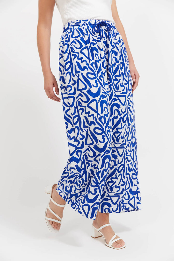 Blue patterned Haven pants worn by a person on a white background