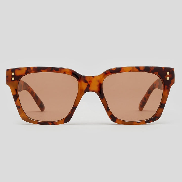 Tortoiseshell square sunglasses with brown lenses, featuring small gold metal accents on the temples, shown against a light gray background.
