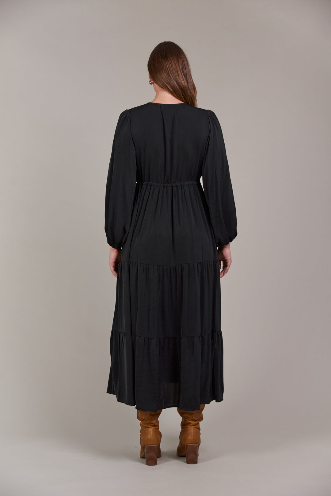 The Elsie Maxi Dress is the ultimate expression of effortless sophistication. Its flattering V-neck flows seamlessly down to an adjustable drawstring, designed to enhance and define your figure. Available from www.thecollectivenz.com