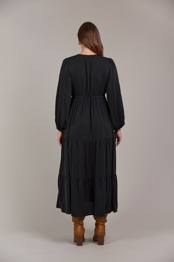 The Elsie Maxi Dress is the ultimate expression of effortless sophistication. Its flattering V-neck flows seamlessly down to an adjustable drawstring, designed to enhance and define your figure. Available from www.thecollectivenz.com