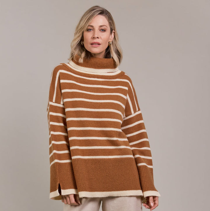 The Katana Roll Neck Knit strikes a balance between timeless and modern, made from sustainably sourced 100% recycled polyester. Available from www.thecollectivenz.com