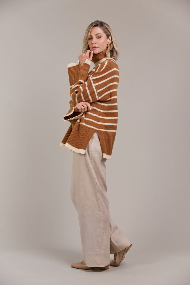 The Katana Roll Neck Knit strikes a balance between timeless and modern, made from sustainably sourced 100% recycled polyester. Available from www.thecollectivenz.com