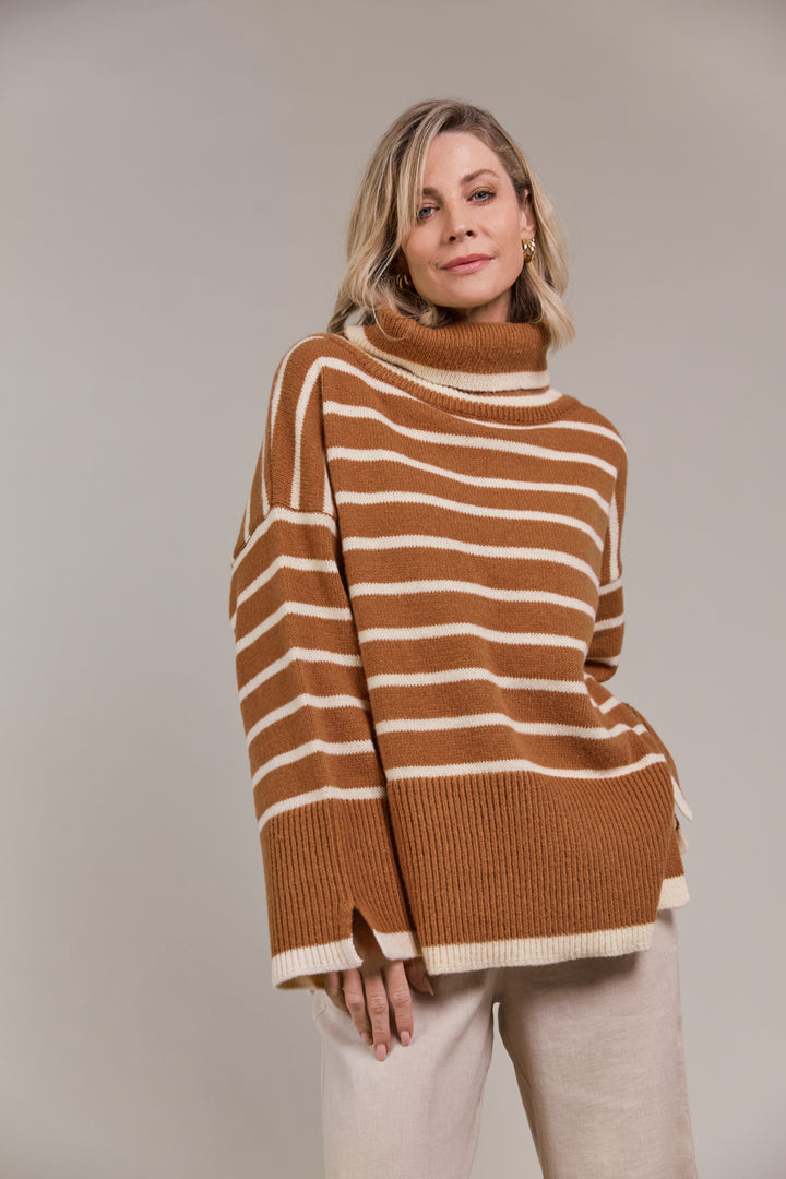 The Katana Roll Neck Knit strikes a balance between timeless and modern, made from sustainably sourced 100% recycled polyester. Available from www.thecollectivenz.com
