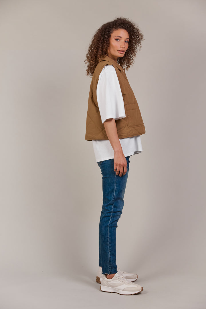 Designed with purpose, the Pepi Vest is crafted from 100% cotton and features a practical zip and press stud closure, convenient patch pockets, and an adjustable drawstring for the perfect fit. Available from www.thecollectivenz.com