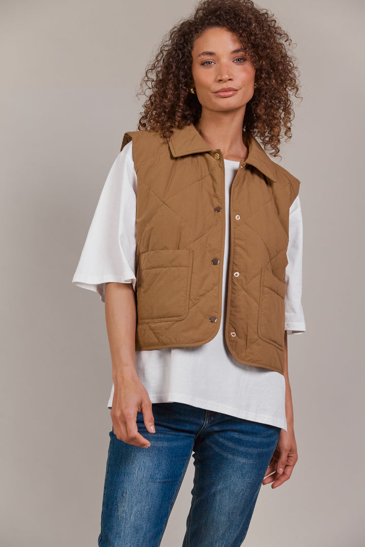 Designed with purpose, the Pepi Vest is crafted from 100% cotton and features a practical zip and press stud closure, convenient patch pockets, and an adjustable drawstring for the perfect fit. Available from www.thecollectivenz.com