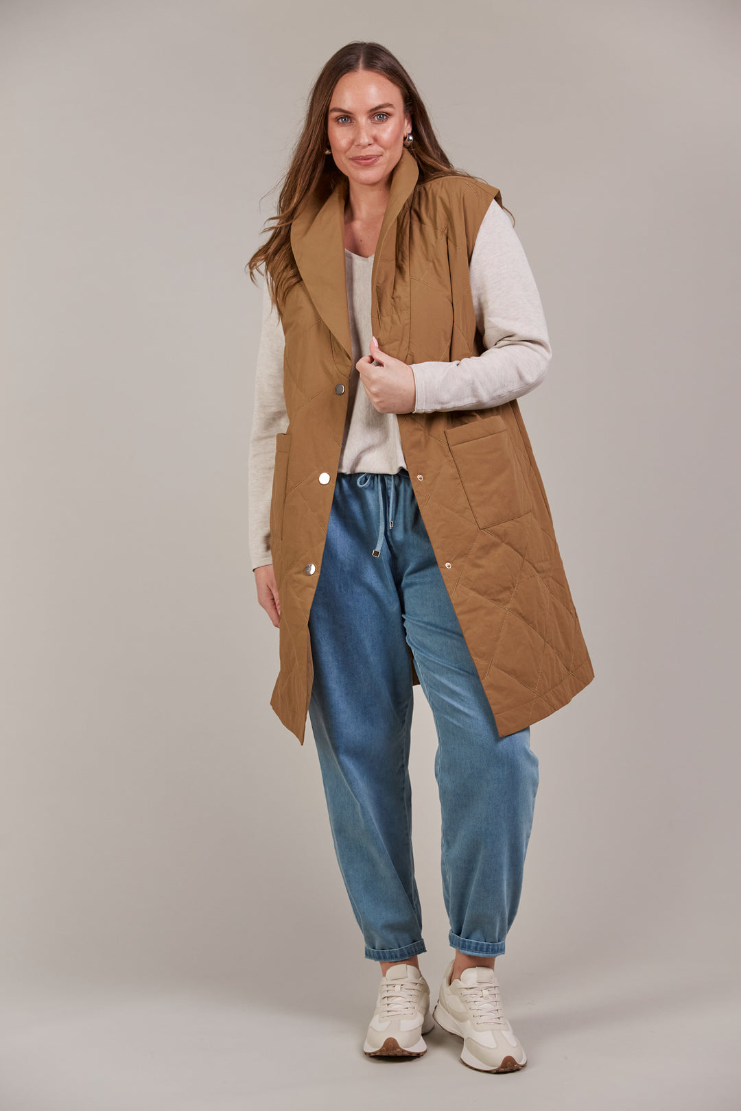 Enhance your outerwear collection with the Argo Long Line Vest. This stylish, quilted cotton vest is designed for comfort and warmth, featuring a lapel with a three-button press stud closure and a knee-length cut to keep the chill at bay. Available from www.thecollectivenz.com