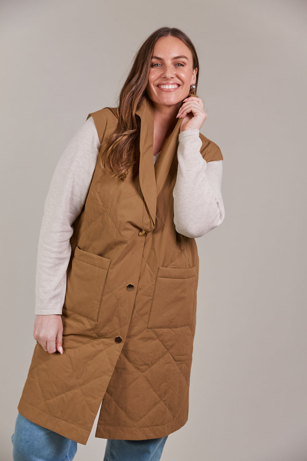 Enhance your outerwear collection with the Argo Long Line Vest. This stylish, quilted cotton vest is designed for comfort and warmth, featuring a lapel with a three-button press stud closure and a knee-length cut to keep the chill at bay. Available from www.thecollectivenz.com