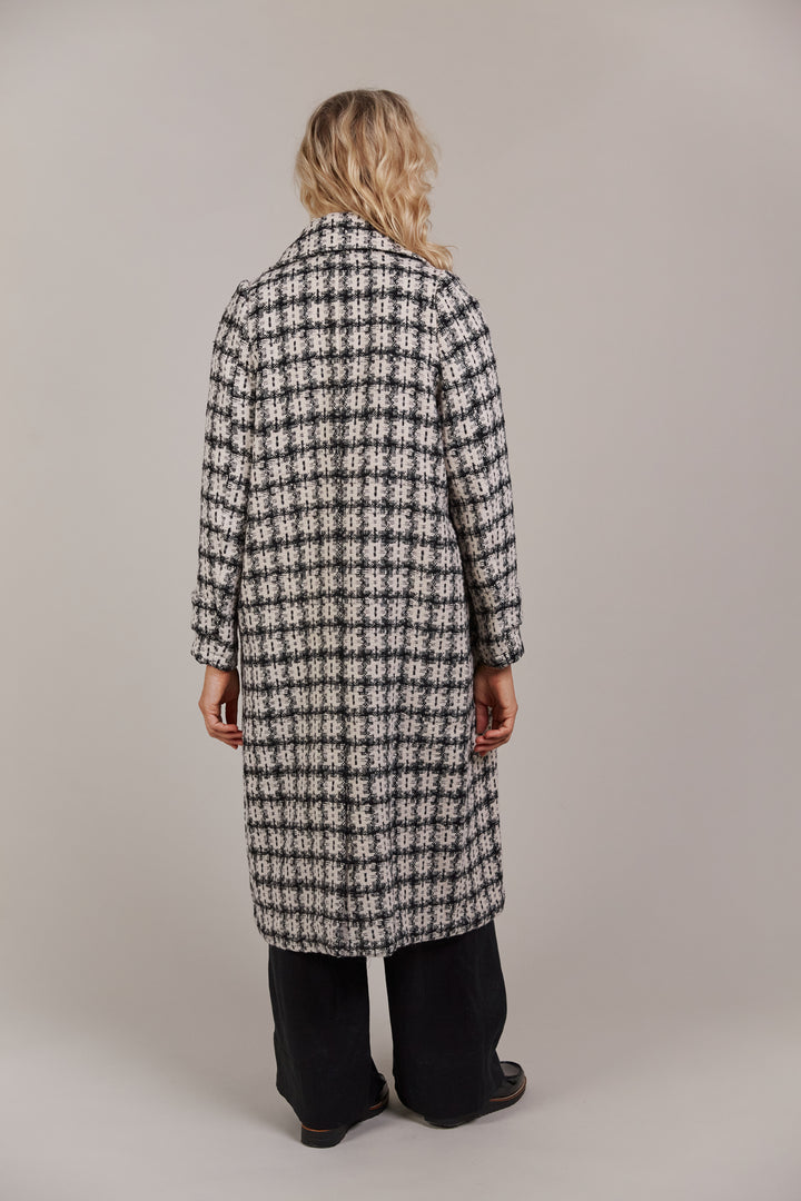 Discover refined winter styling with the Aman Coat, your ultimate companion for a polished, sophisticated look. Available from www.thecollectivenz.com