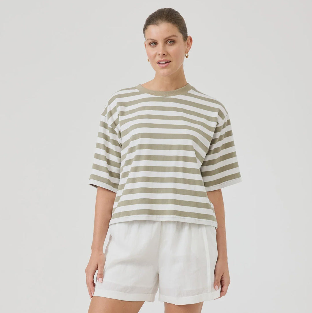 Woman wearing a striped shirt and white shorts on a white background