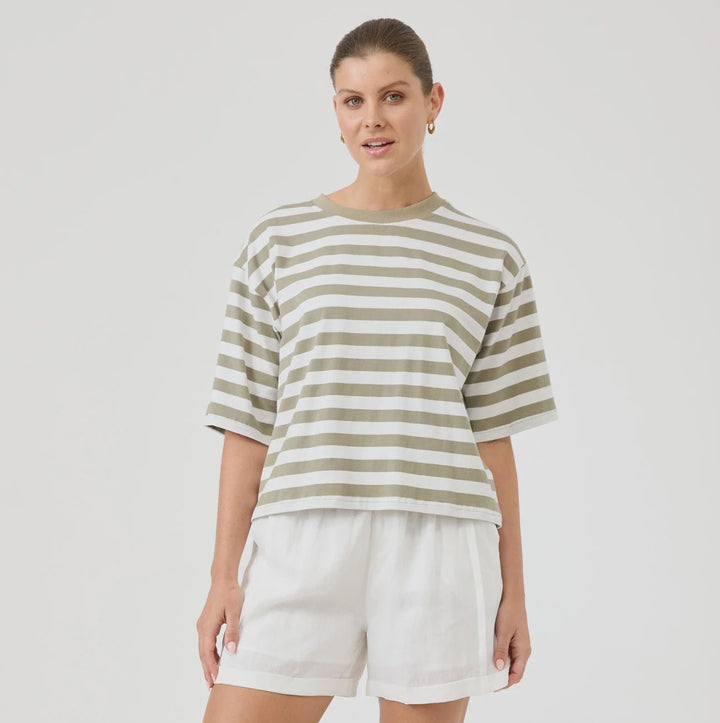 Woman wearing a striped shirt and white shorts on a white background
