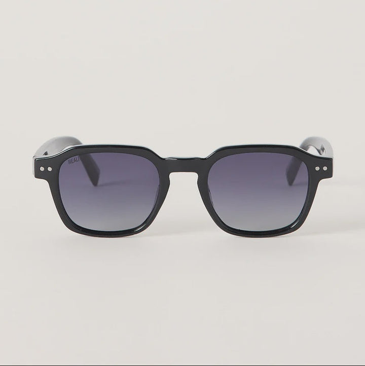 Black square sunglasses with gradient gray lenses, shown from the front on a light gray background.