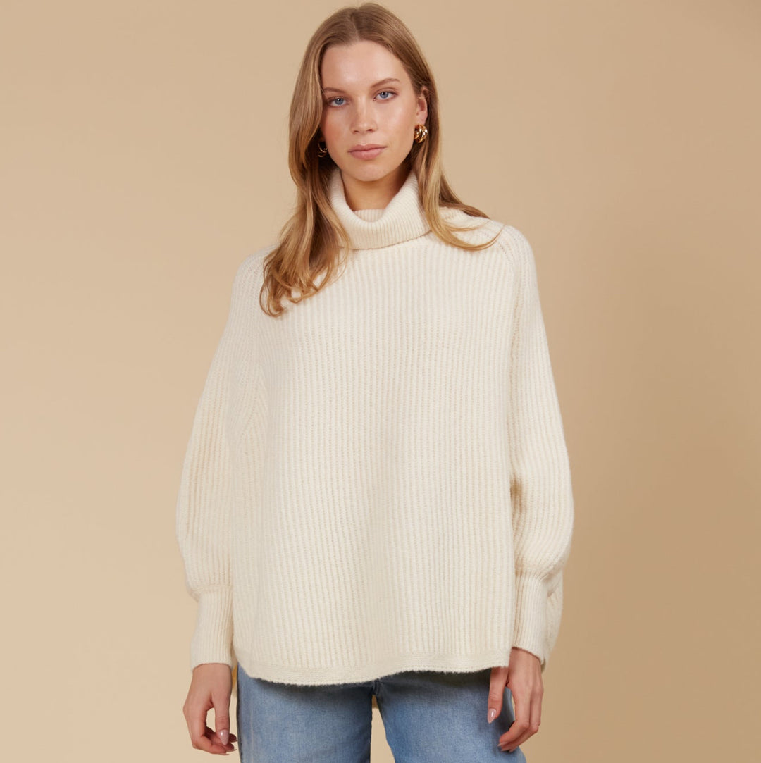 Made from a luxurious wool and recycled polyester blend, the Miru Poncho features a longer length and a rolled turtleneck, making it ideal for cooler weather. Available from www.thecollectivenz.com
