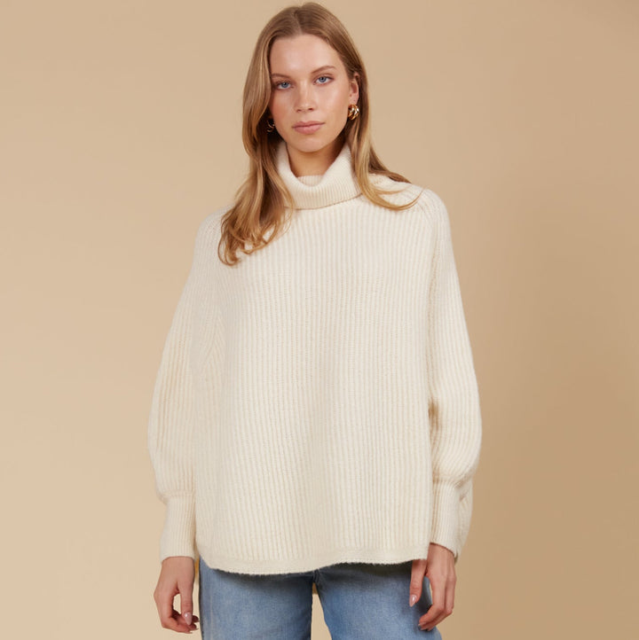 Made from a luxurious wool and recycled polyester blend, the Miru Poncho features a longer length and a rolled turtleneck, making it ideal for cooler weather. Available from www.thecollectivenz.com