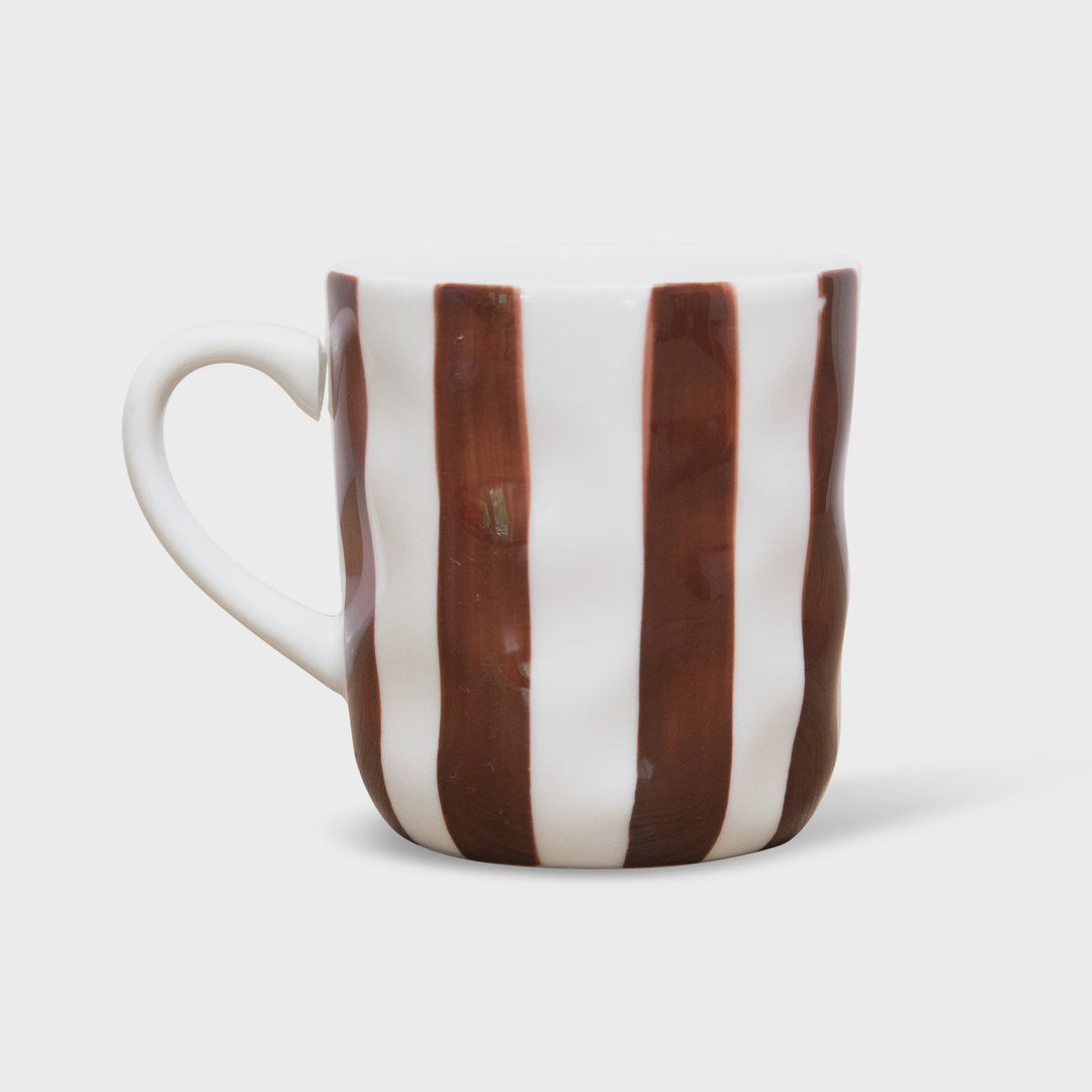Ceramic mug with brown and white stripes on a light gray background