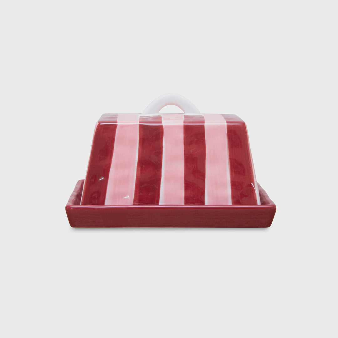 Red and white striped ceramic butter dish on a white background