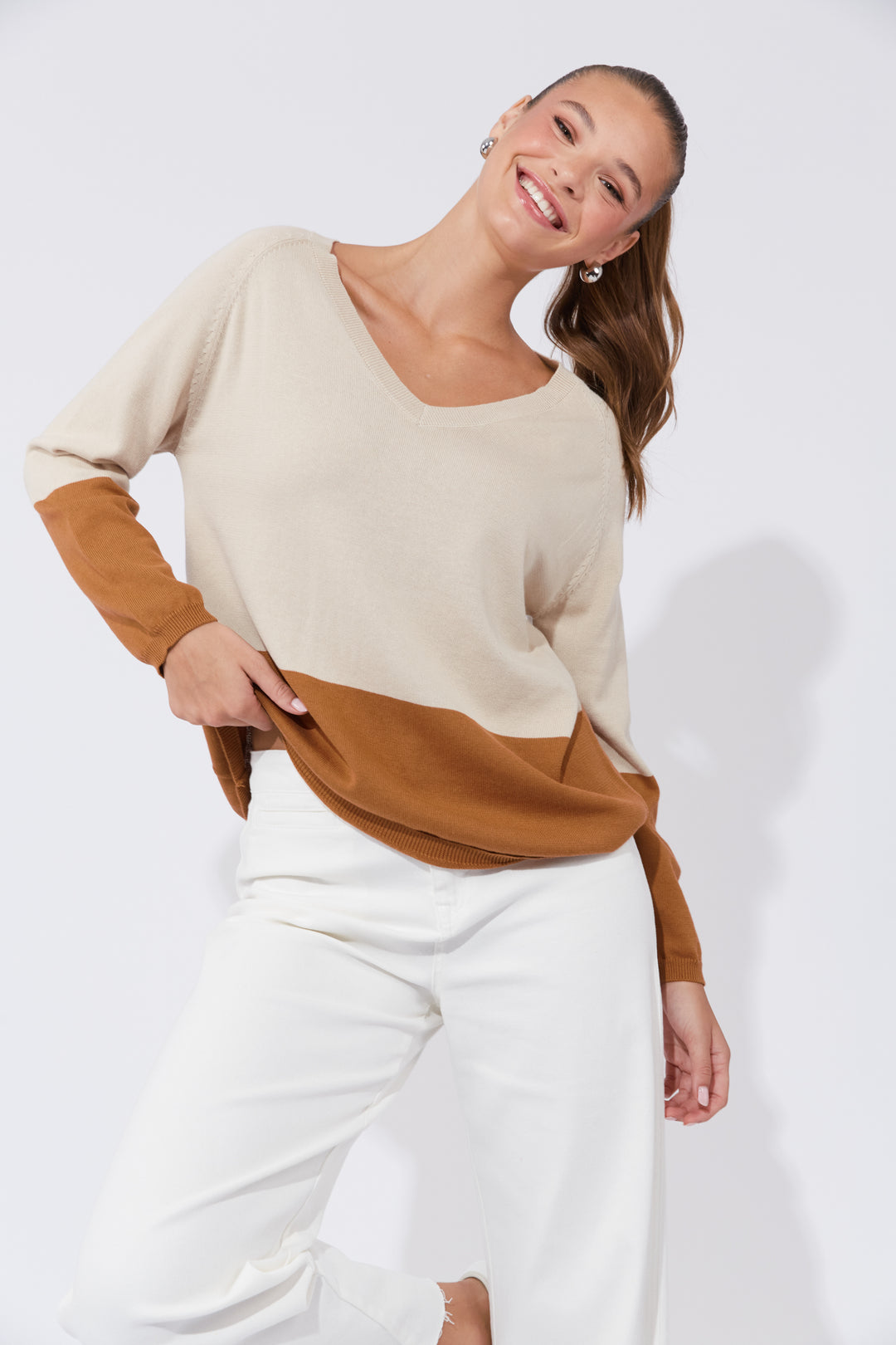 The Casablanca Block Knit combines simplicity with a touch of modern flair. This easygoing boxy sweater is designed with raglan sleeves and a V-neck for a relaxed fit. Available from www.thecollectivenz.com