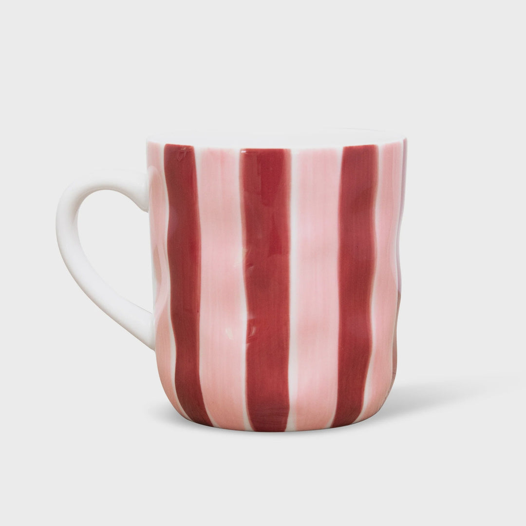 Striped mug with pink and red vertical stripes on a white background