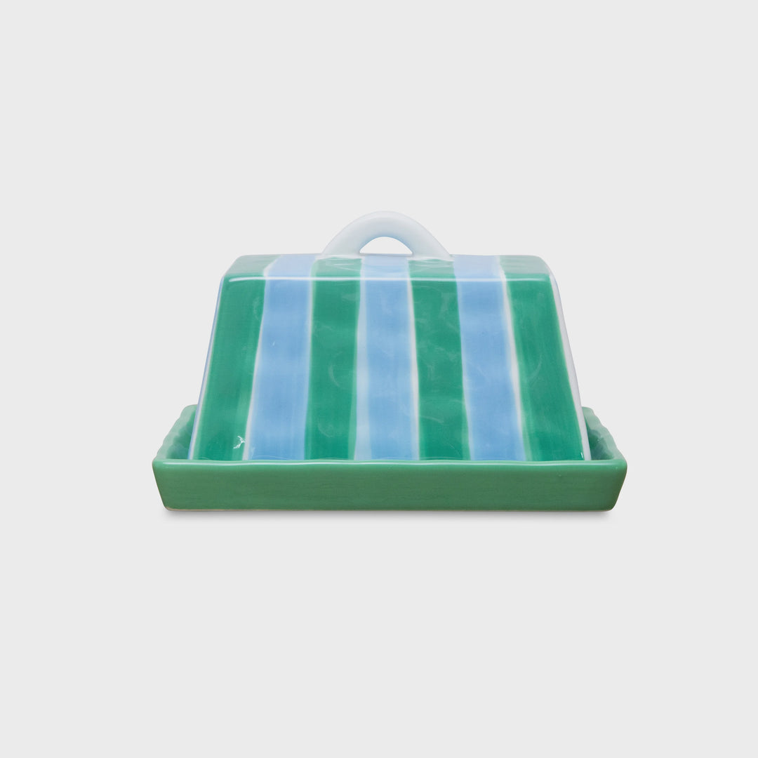 Green and blue striped butter dish on a white background