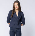 Woman wearing a Billie the label navy blue blazer on a white background