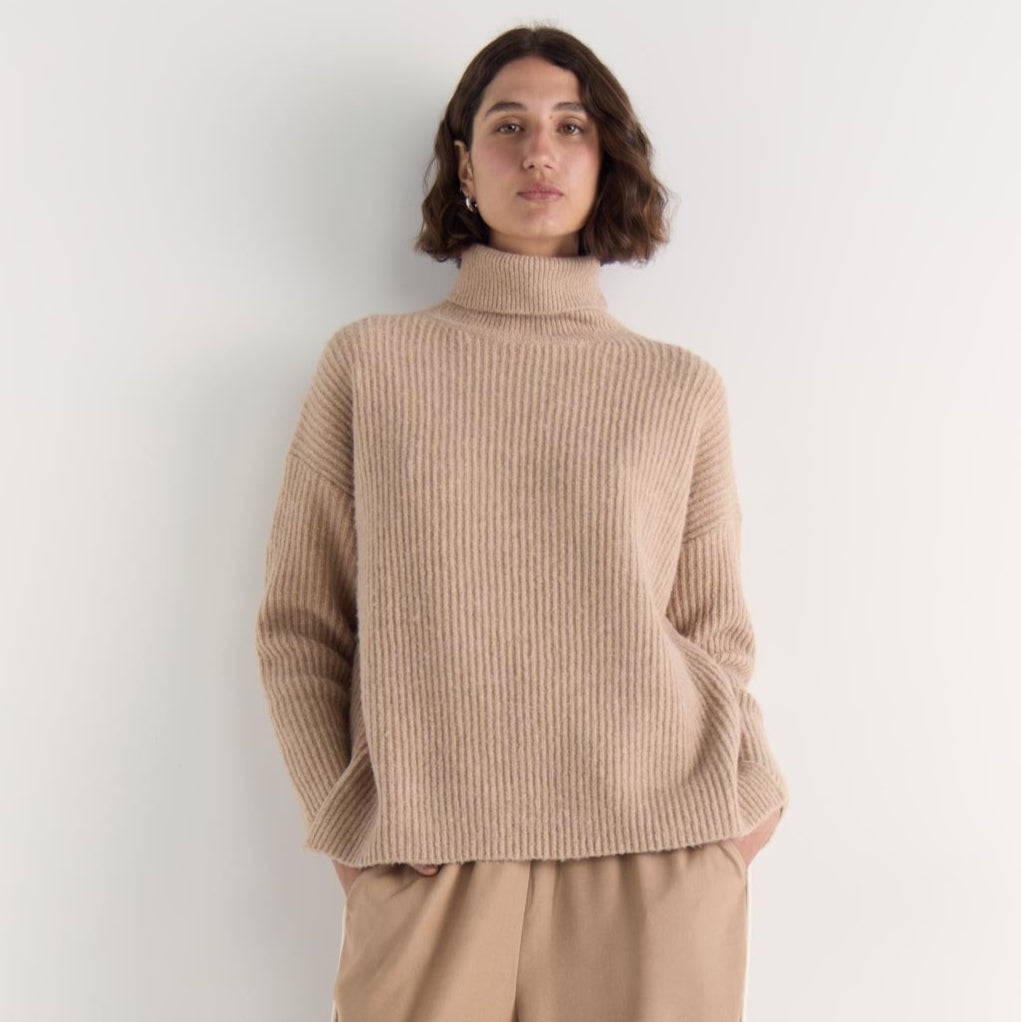 The Cassia Roll Neck Jumper is your answer to elevated everyday comfort. Crafted in a soft, plush knit, this oversized silhouette features a relaxed drop shoulder and cozy roll neck that keeps things snug without sacrificing style. Available from www.thecollectivenz.com