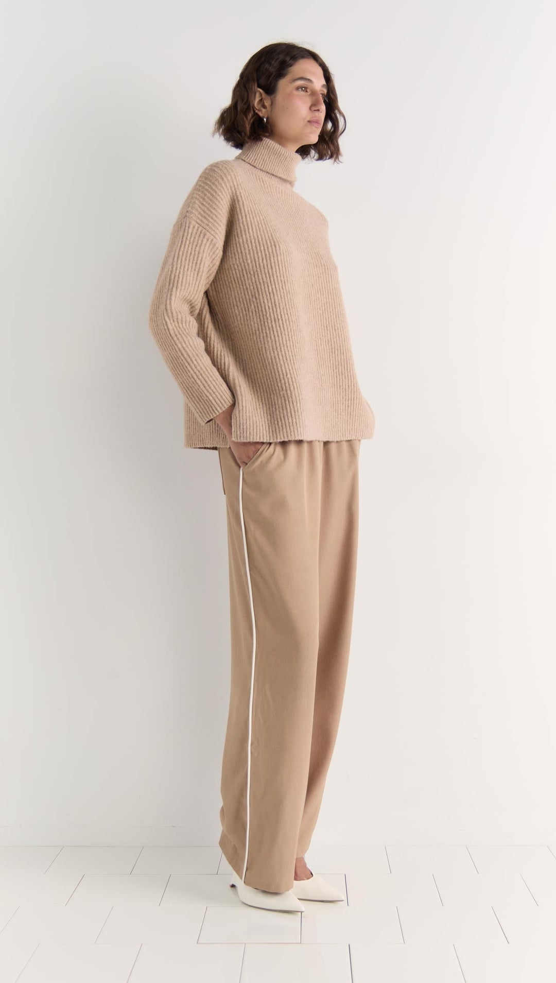 The Cassia Roll Neck Jumper is your answer to elevated everyday comfort. Crafted in a soft, plush knit, this oversized silhouette features a relaxed drop shoulder and cozy roll neck that keeps things snug without sacrificing style. Available from www.thecollectivenz.com