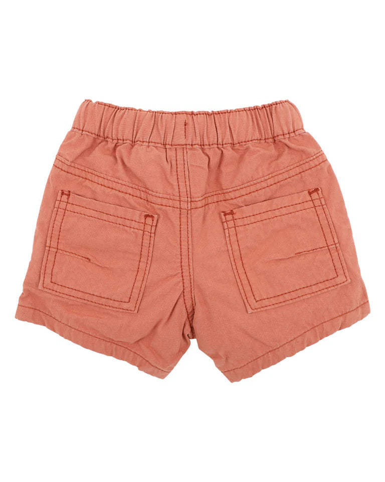 Bebe rust shorts with two front pockets on a white background