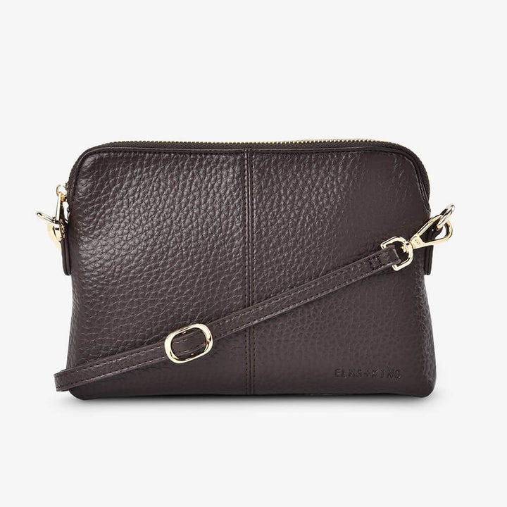 Brown leather crossbody bag with gold accents on a white background