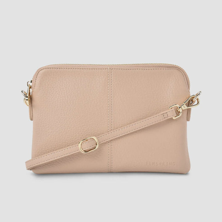 Beige handbag with gold accents on a white background