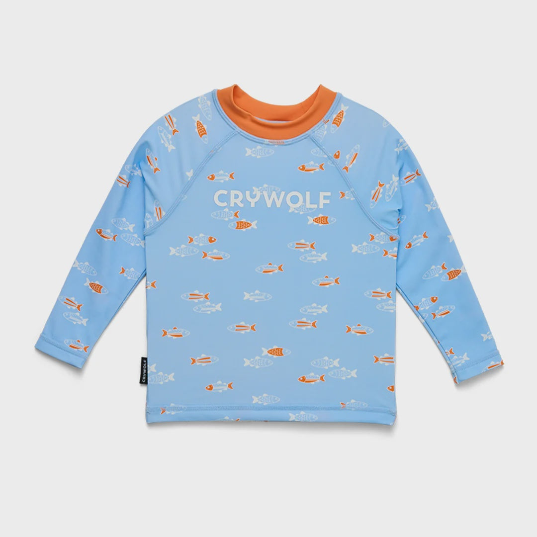 A light blue long-sleeve swim shirt with an orange crew neck, featuring a repeating pattern of orange and white fish, and the brand name 'CRYWOLF' printed across the chest.