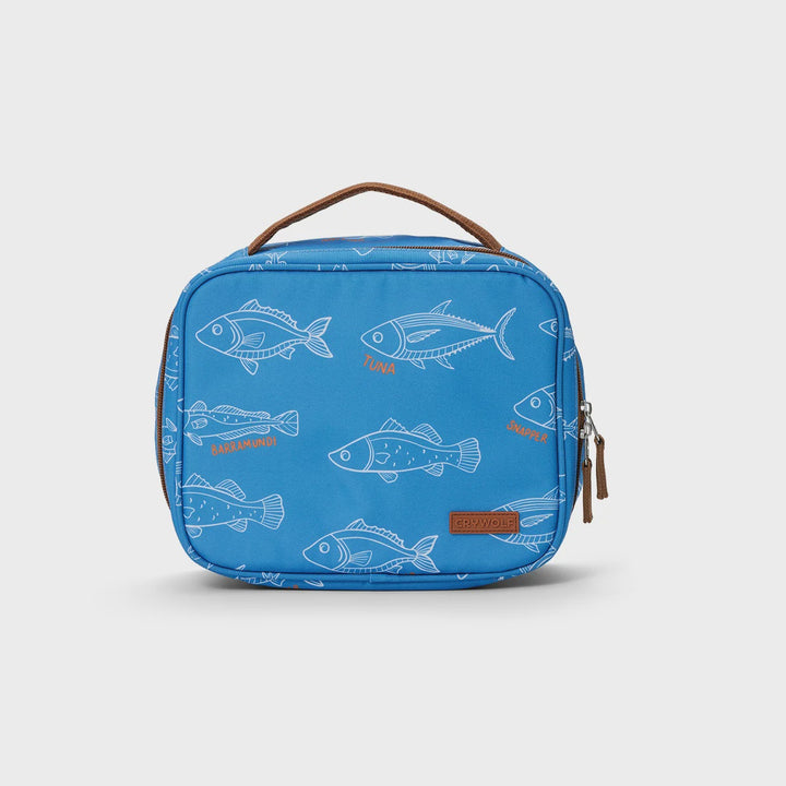 A blue lunch bag with a repeating white fish pattern and brown leather handle and zipper pull, photographed on a clean white background.
