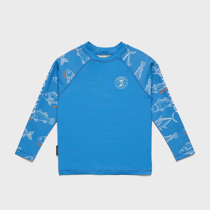 A bright blue long-sleeve children's rash guard featuring a white fish and squid print on the sleeves and a white circular logo on the chest, displayed flat against a light gray background.