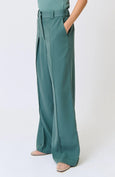 Teal wide-leg pants worn by a person on a white background