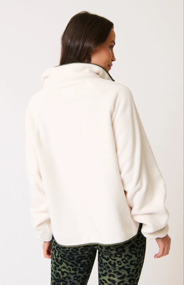 Person wearing a white cartel & willow Mattie pullover and leopard print pants on a plain background