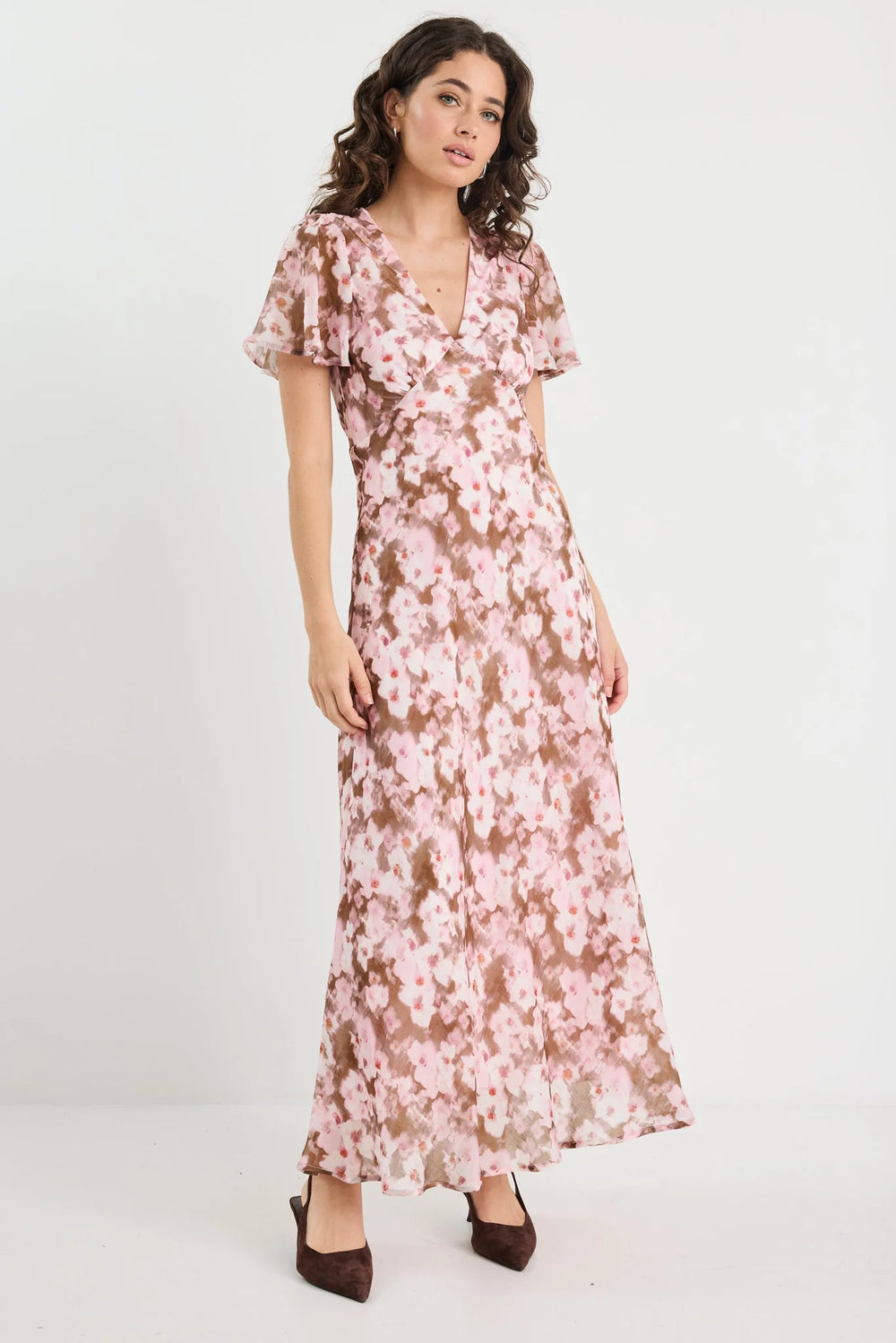 Woman wearing a floral dress on a white background
