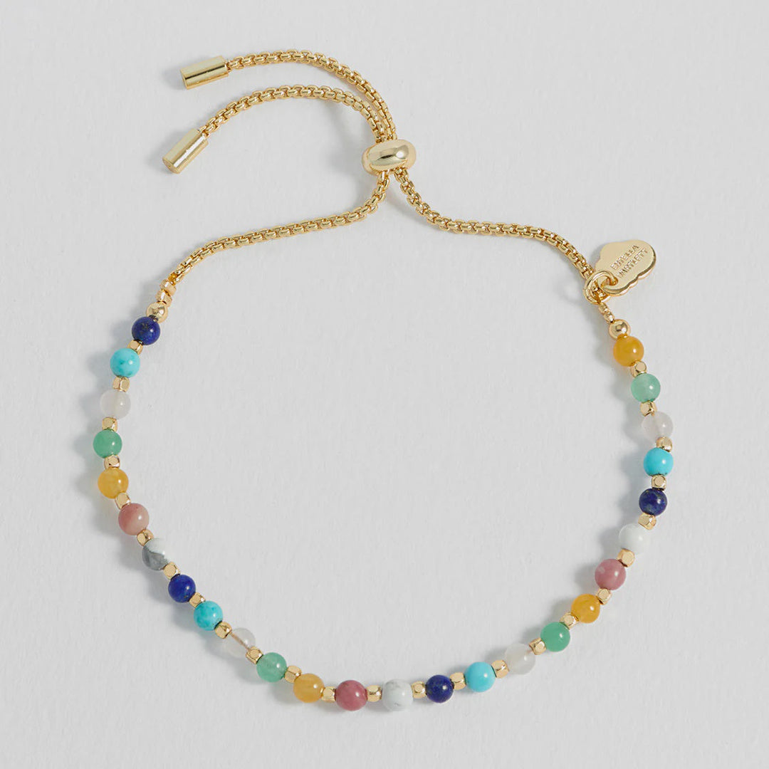 Multicolored beaded bracelet on a light gray background