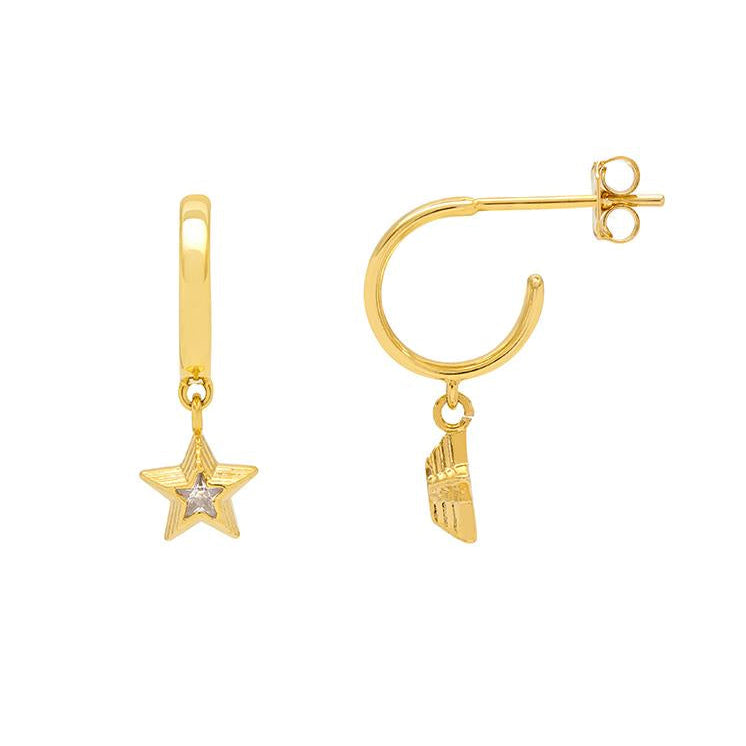 Gold earrings with star and foot charm on a white background