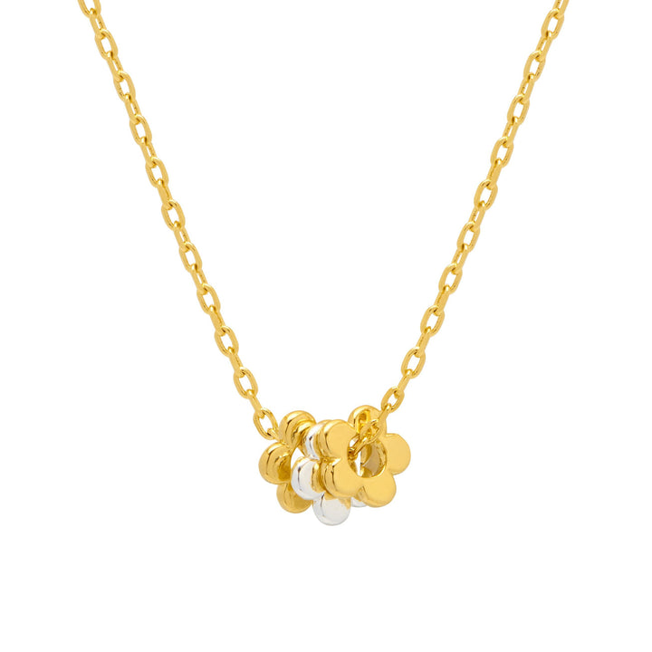 Gold necklace with floral pendant and pearl on a white background