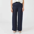 Woman wearing a white blouse and Eb & Ive navy pants on a white background