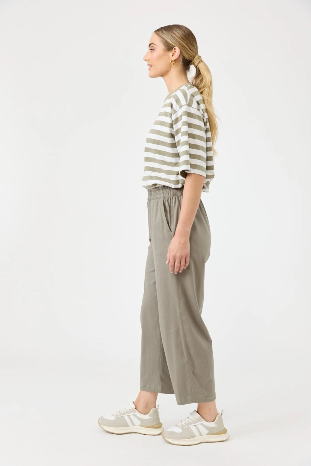Woman wearing a striped shirt and Eb & Ive wide-leg pants on a white background
