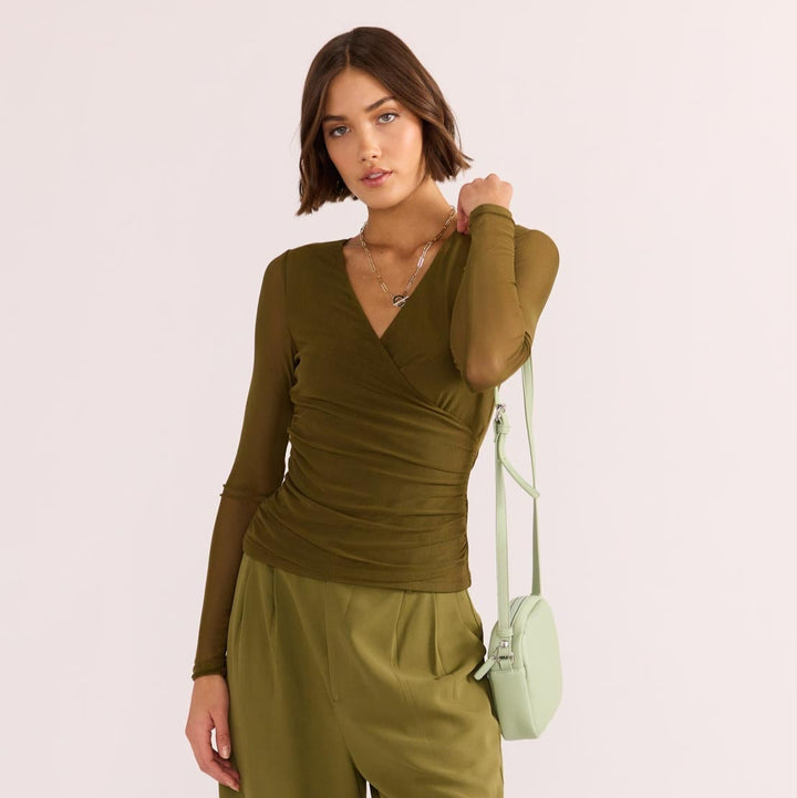 The Elodie Mesh Wrap Top by MINKPINK will easily become part of your capsule wardrobe. Available from www.thecollectivenz.com