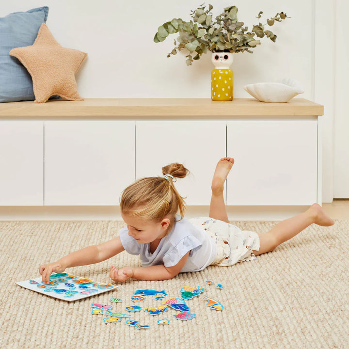 Child playing with a puzzle on the floor in a home setting