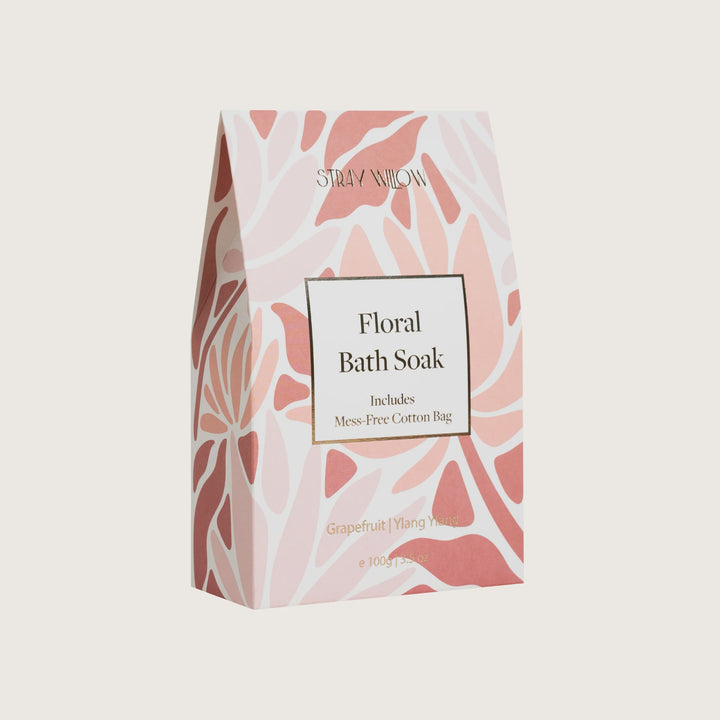 Floral bath soak packaging with pink and white design on a beige background