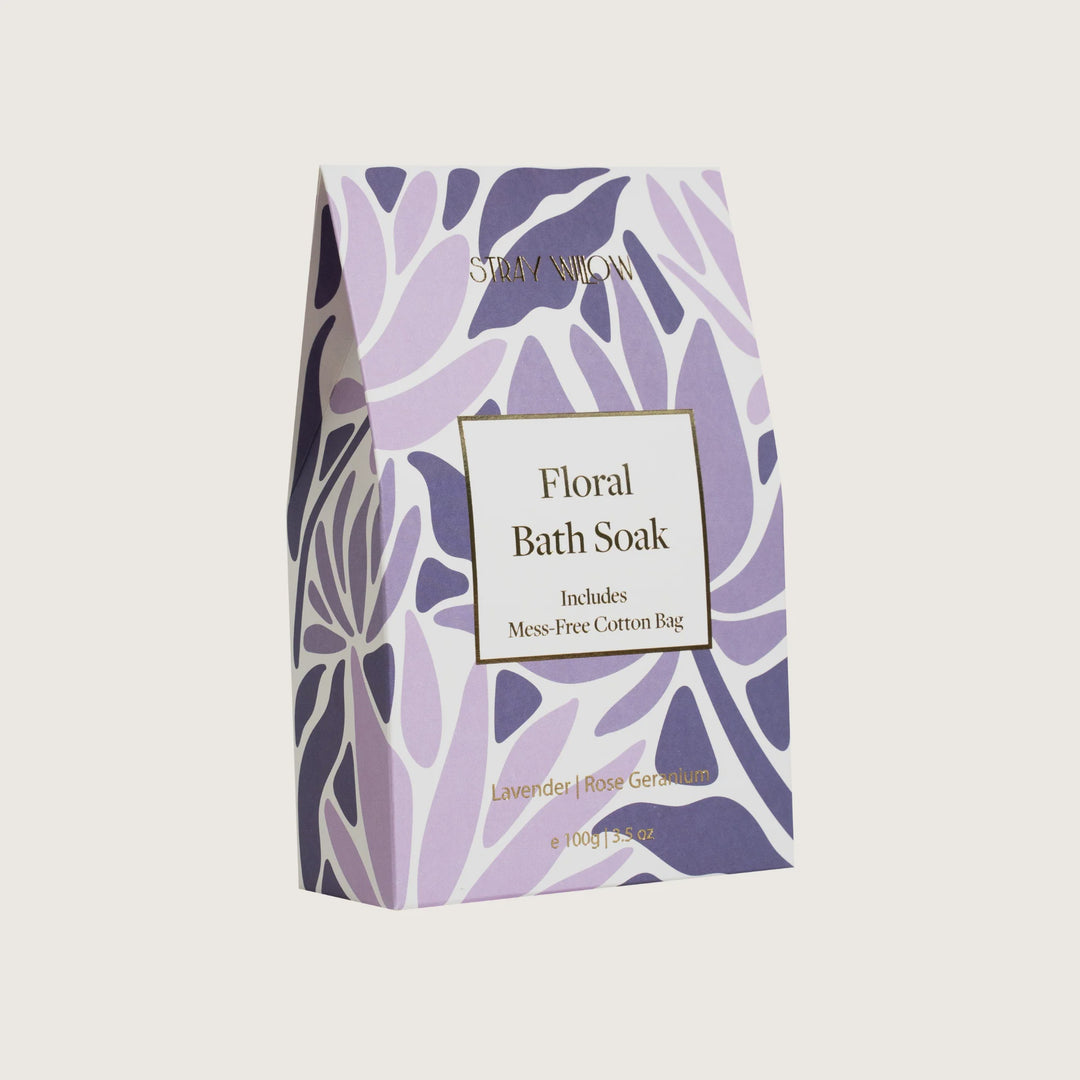 Floral bath soak packaging with purple leaf design on a white background