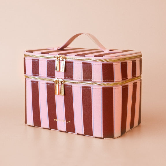 Fox & Fallow Striped makeup bag with gold zipper on a beige background
