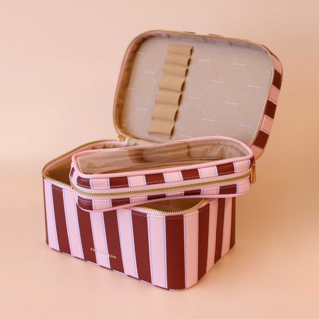 Fox & Fallow Striped makeup bag with open lid on a beige background