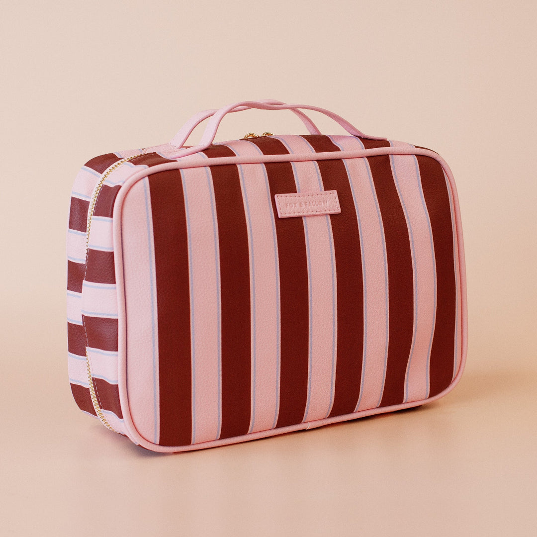 Fox and fallow Striped toiletry bag with a visible brand logo on a beige background